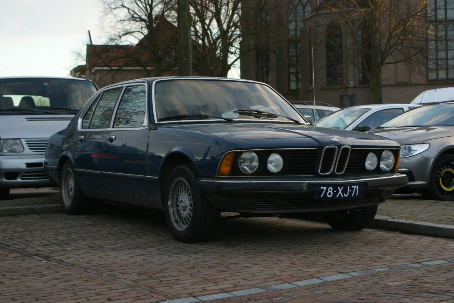 Classic luxury sedan with dual round headlights and kidney grille