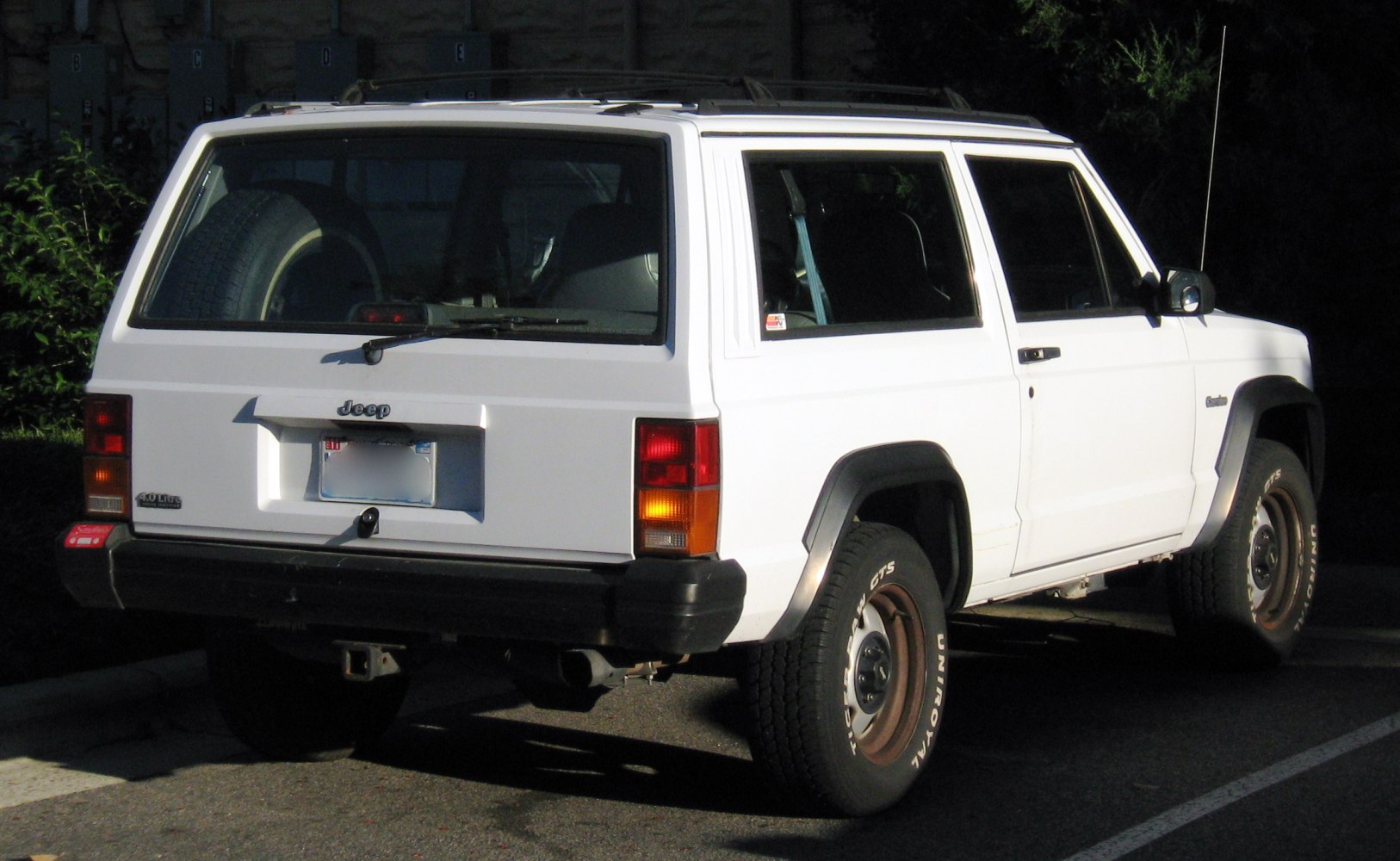 Rear and side view of an SUV with boxy shape and rugged off-road tires.