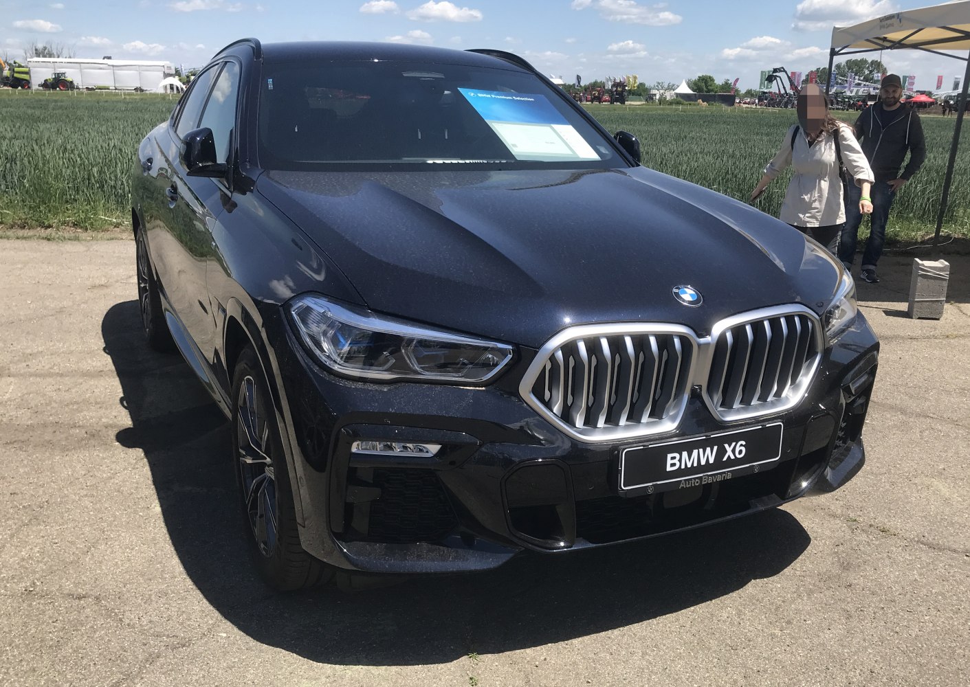Front angled view showing large kidney grille and sharp headlights