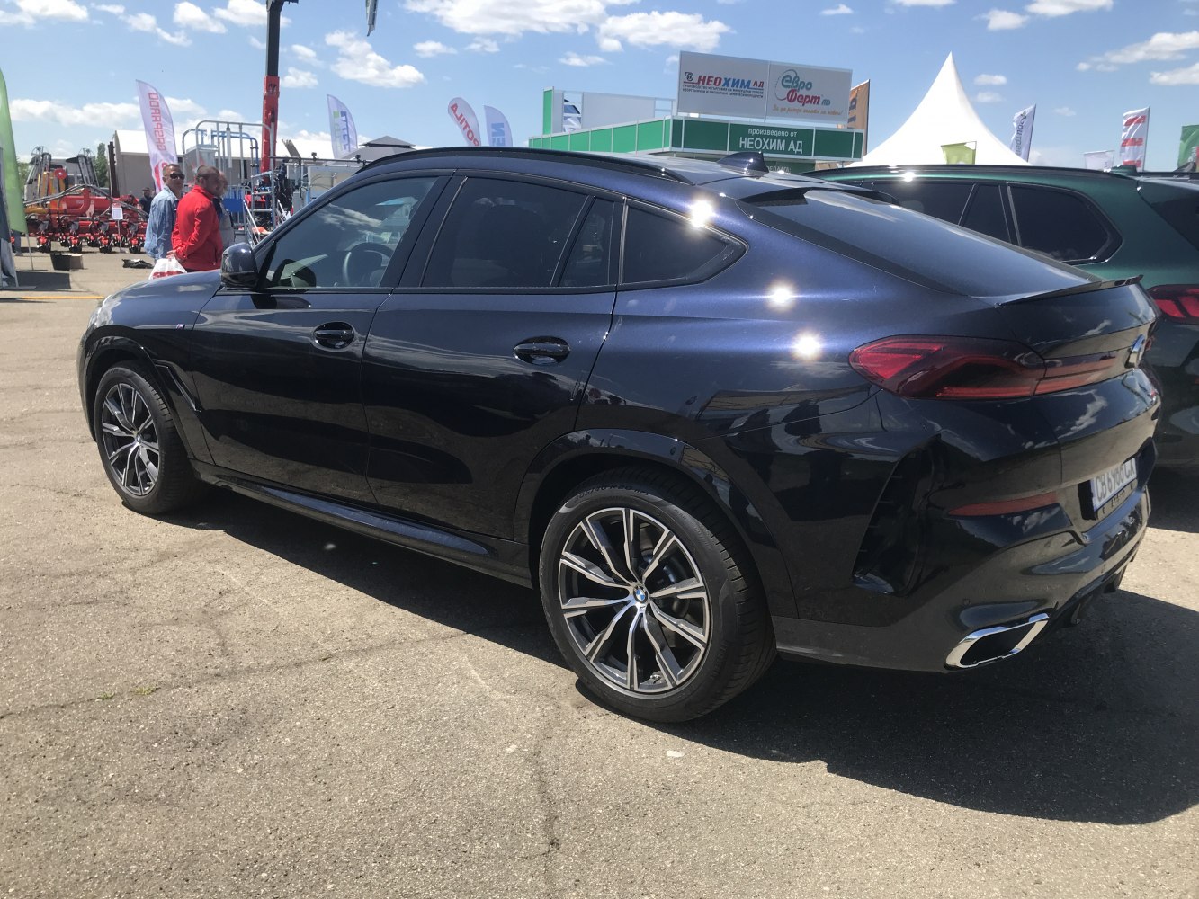 Side and rear view of coupe SUV with alloy wheels and modern taillights.