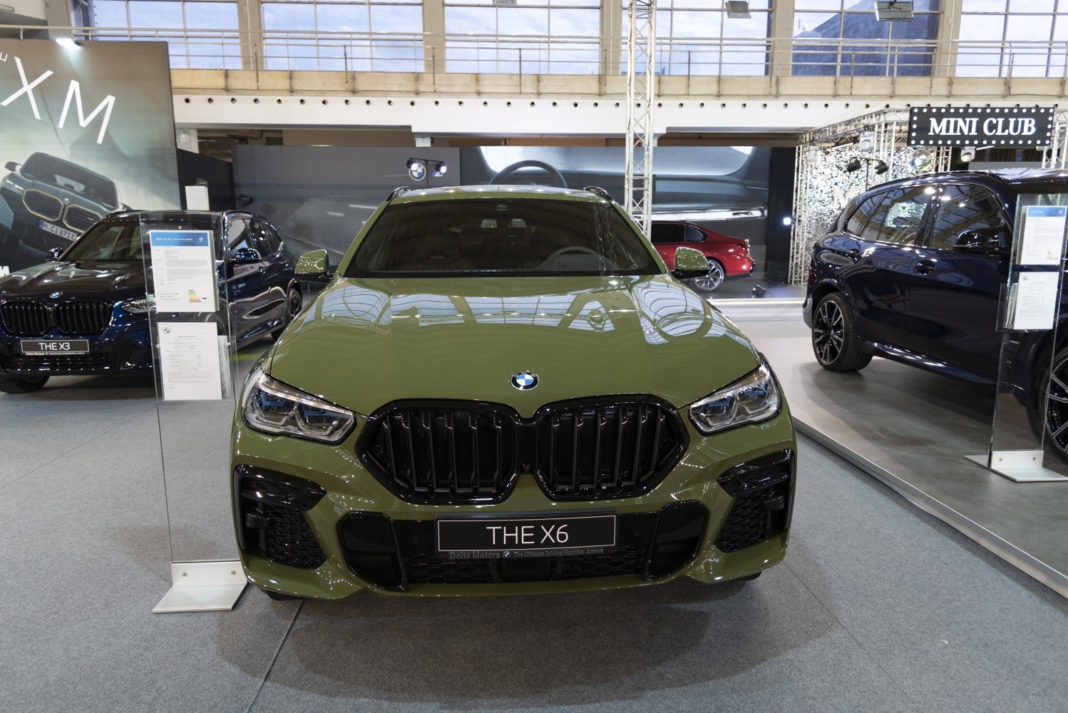 Aggressive kidney grille and sleek headlights of a green SUV front