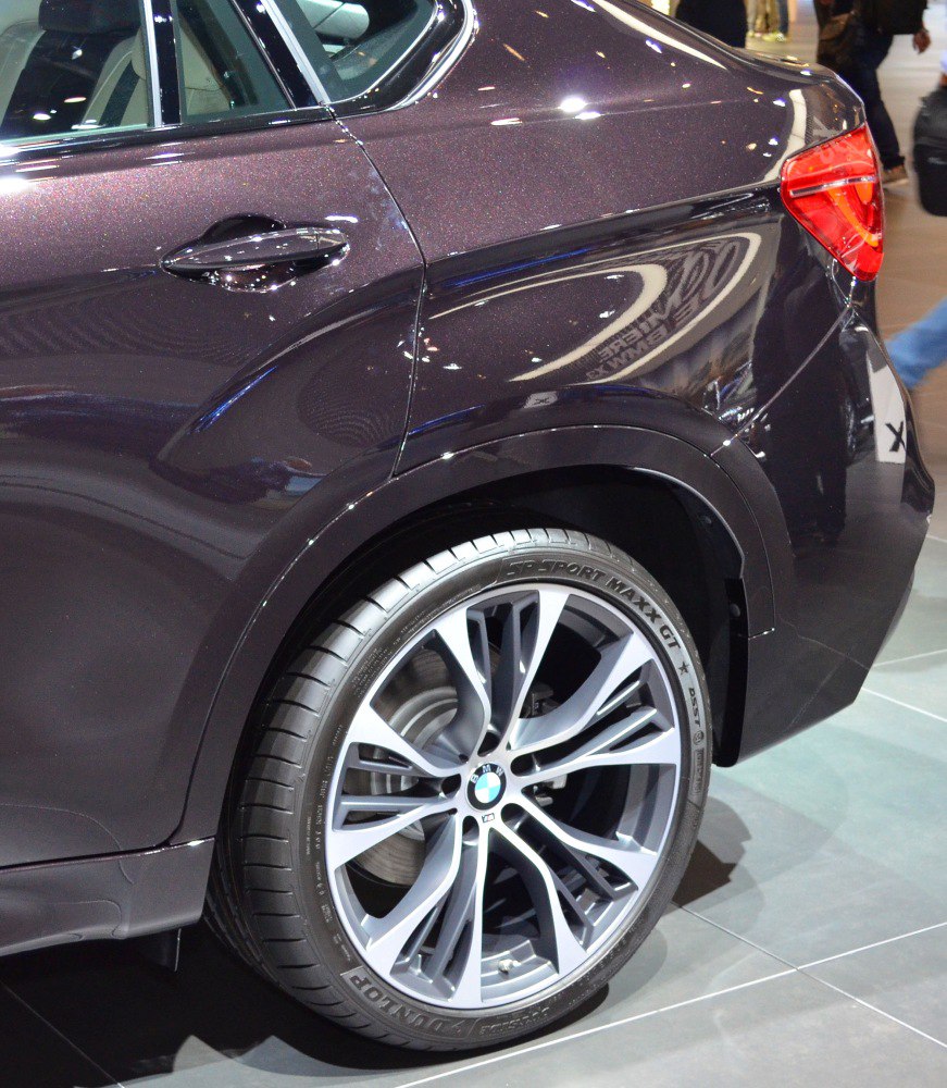 Rear side body with door handle and alloy wheel close-up