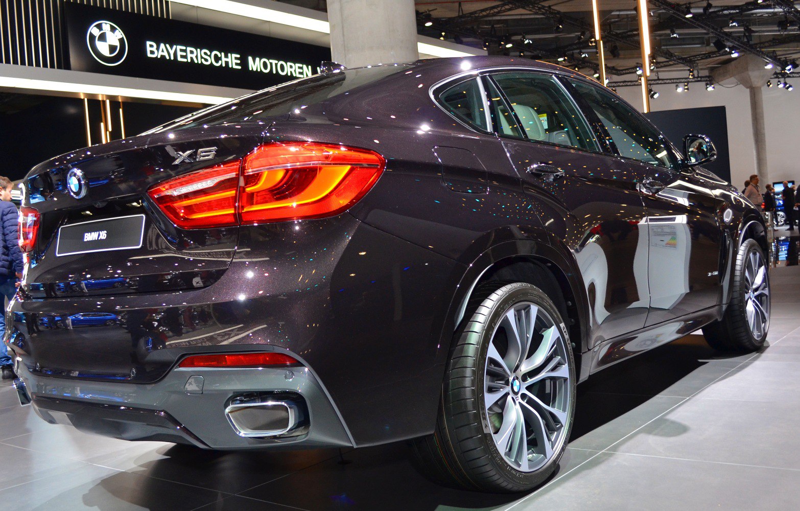 Luxury SUV rear tail lights and dual exhaust design.