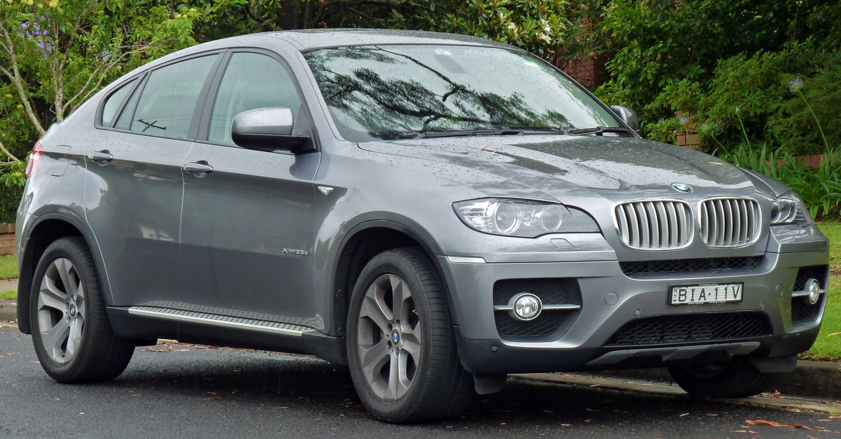 Front side view with kidney grille and coupe SUV profile in rain