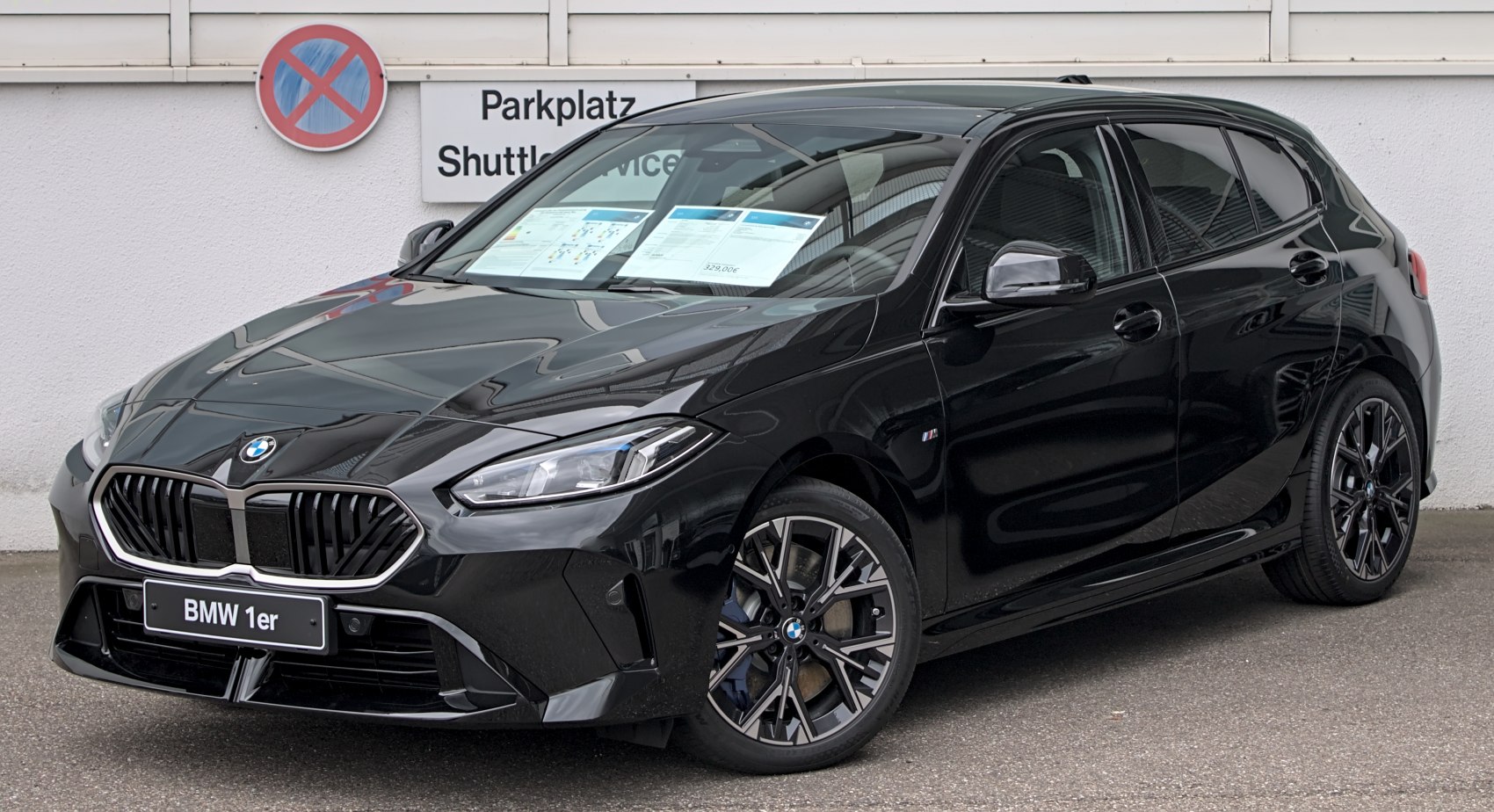Front view and alloy wheels of a sleek black hatchback