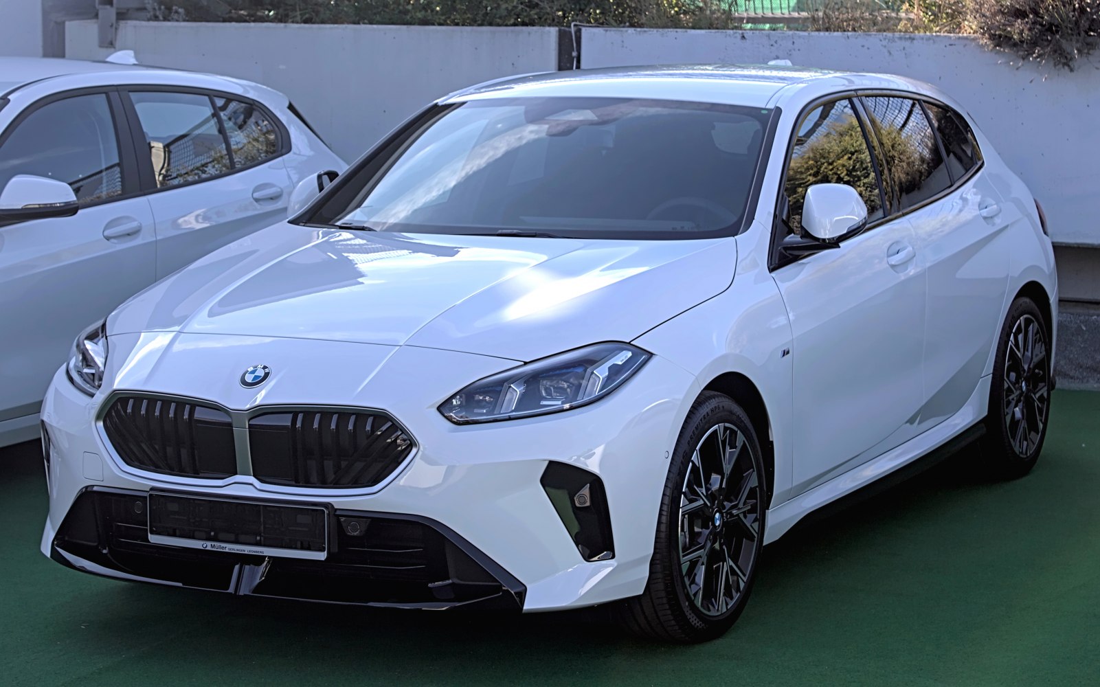 Front view of a modern hatchback with sleek headlights and bold grille