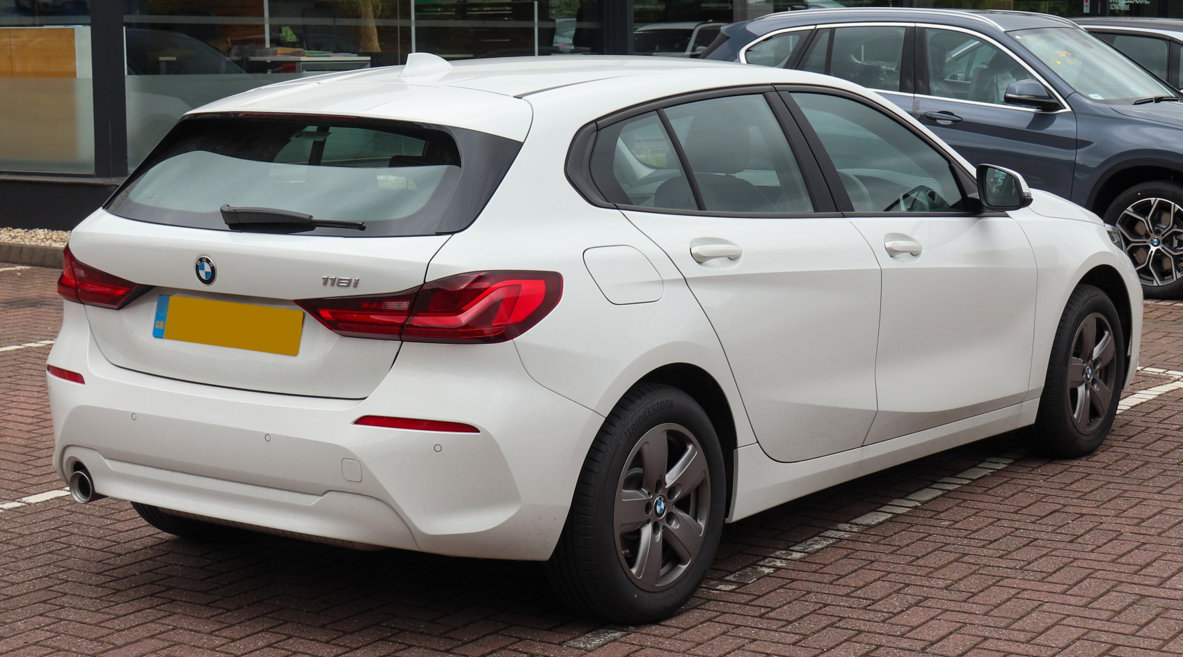 Rear and side view of white modern hatchback with distinct tail lights and five-door layout
