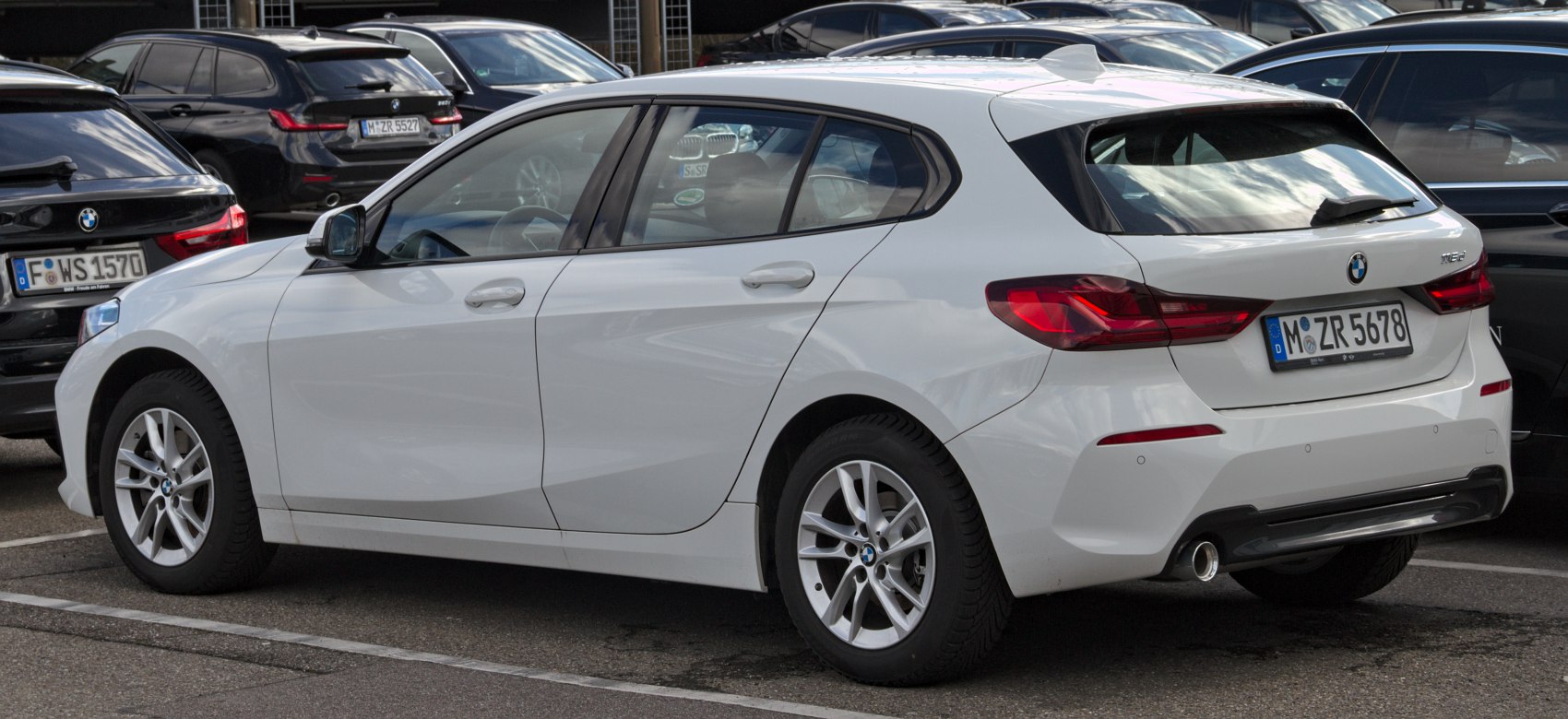 White compact hatchback with rear LED tail lights and alloy wheels.