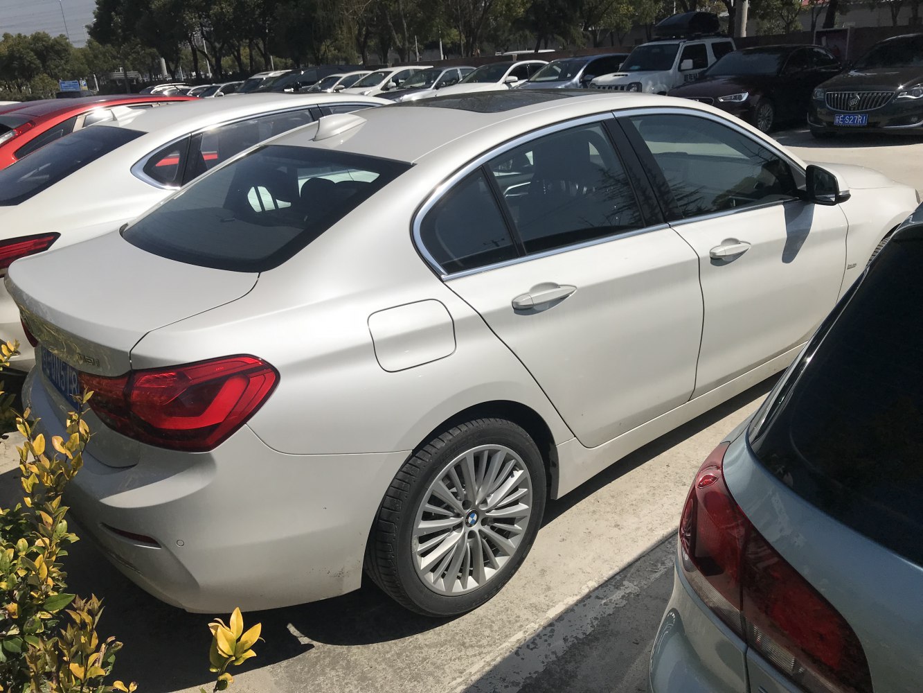 Rear and side profile of a sedan car with alloy wheels