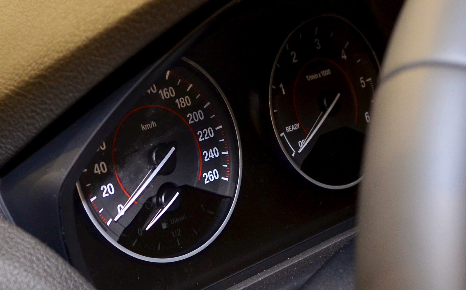 Close-up of car dashboard speedometer and tachometer