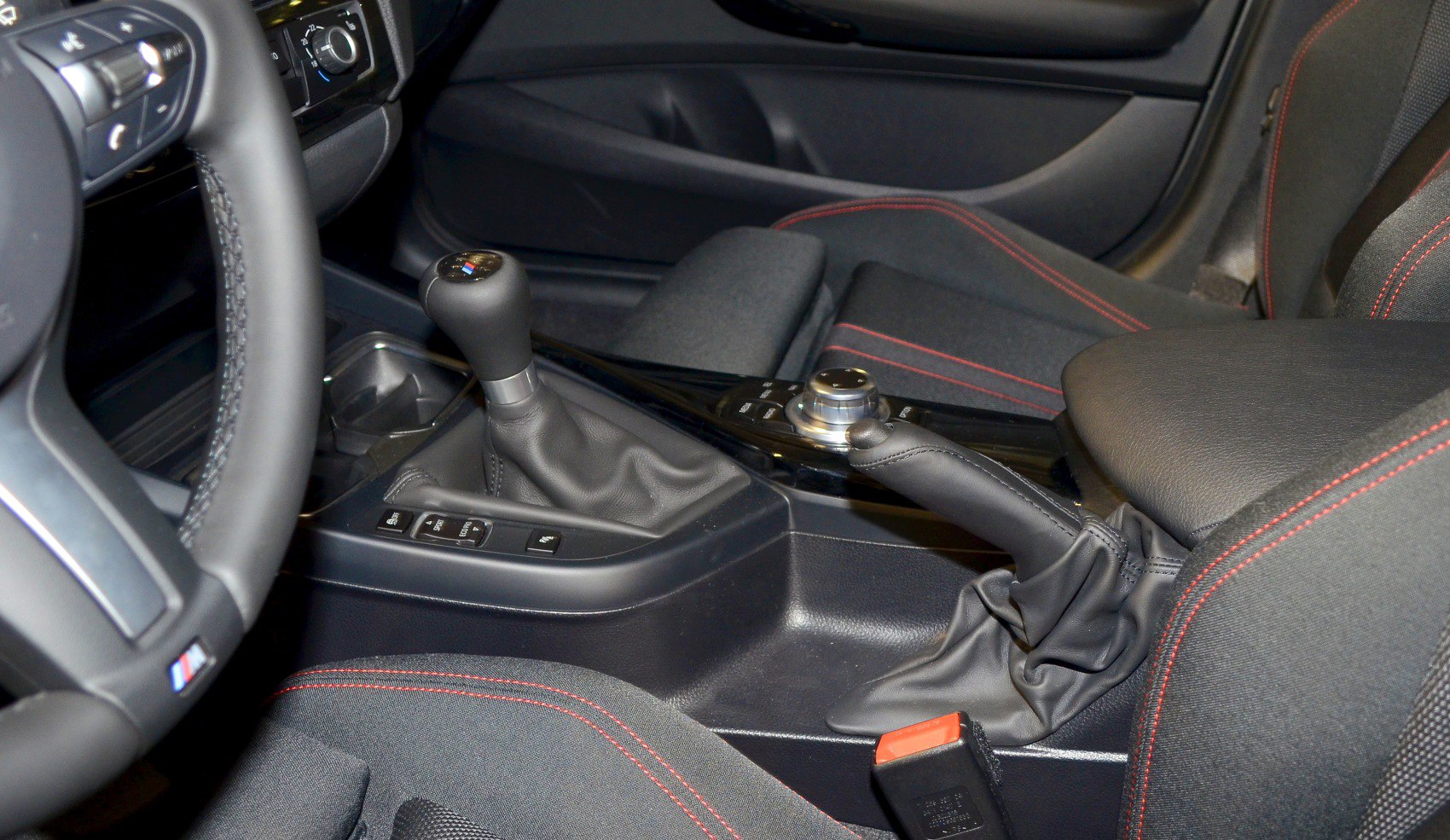 Manual gear shift and handbrake with red stitched upholstery