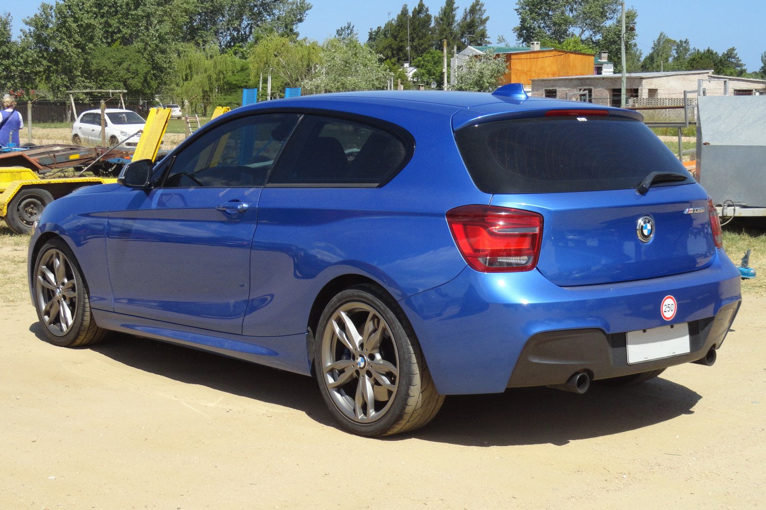 Blue 3-door hatchback with rear tinted windows and alloy wheels