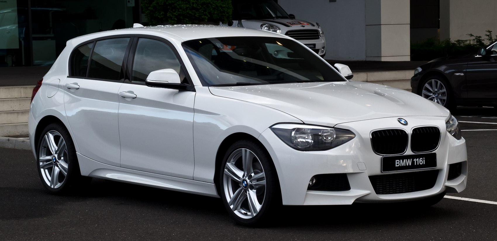 White 5-door hatchback with sharp headlights and alloy wheels