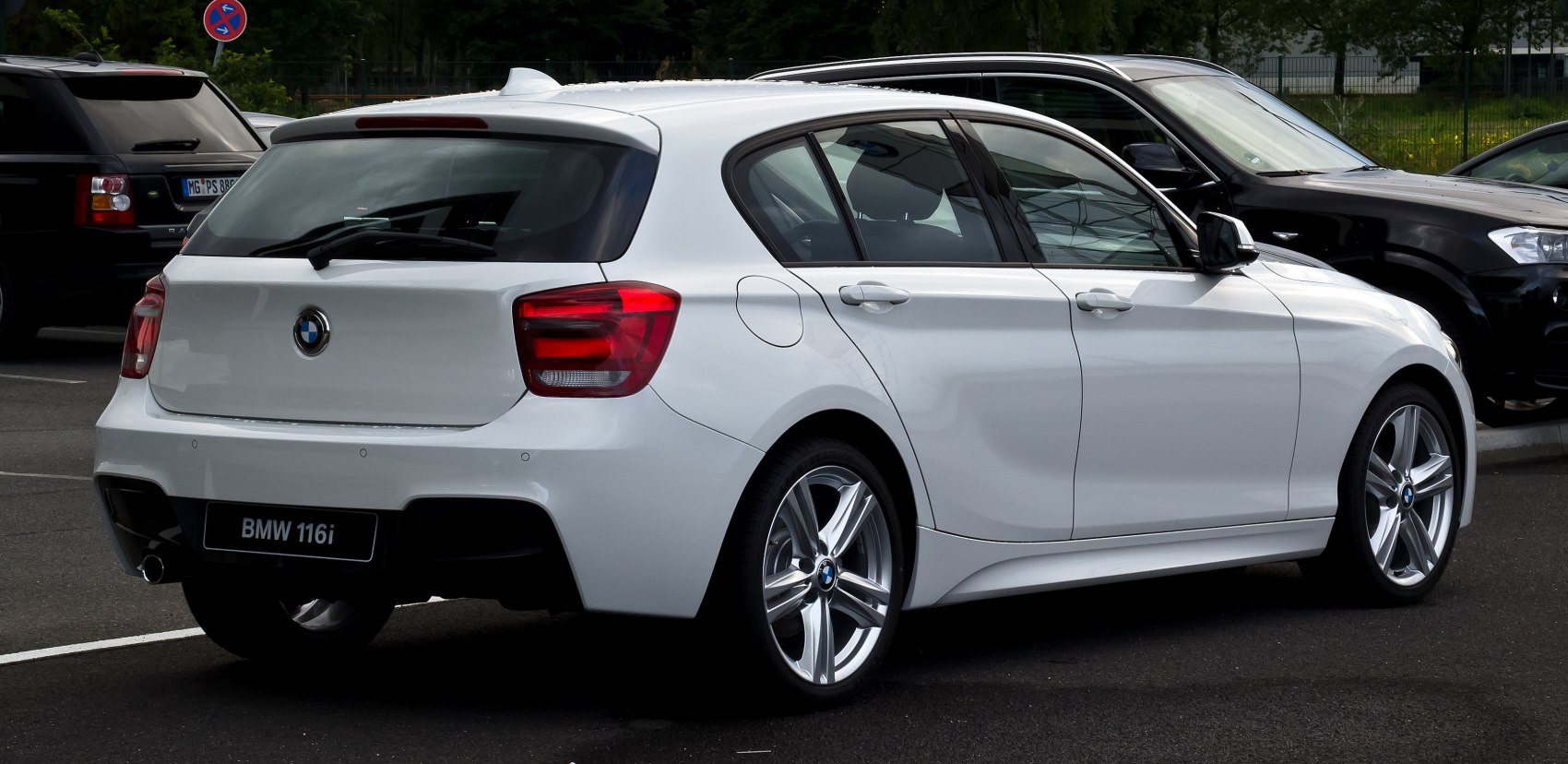Rear side view with tail lights, rear window, and alloy wheels