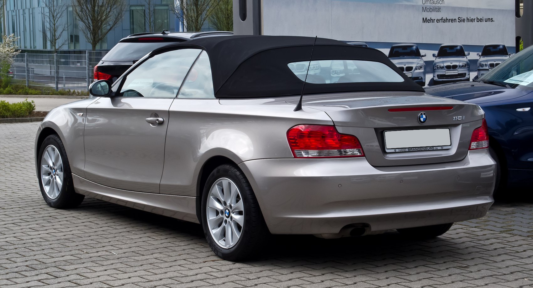Rear view of convertible with soft roof and alloy wheels