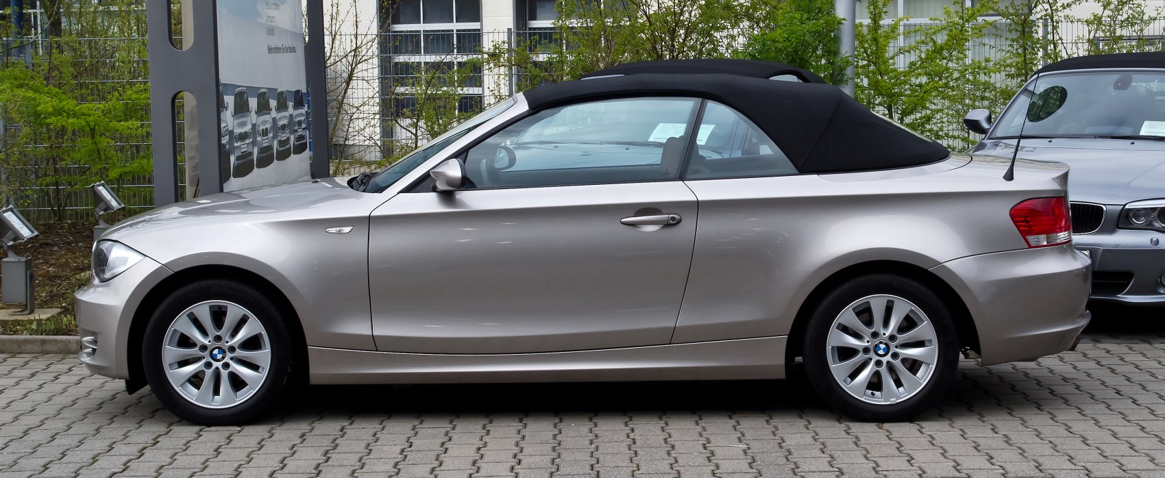 Side profile of a compact convertible with soft fabric roof.