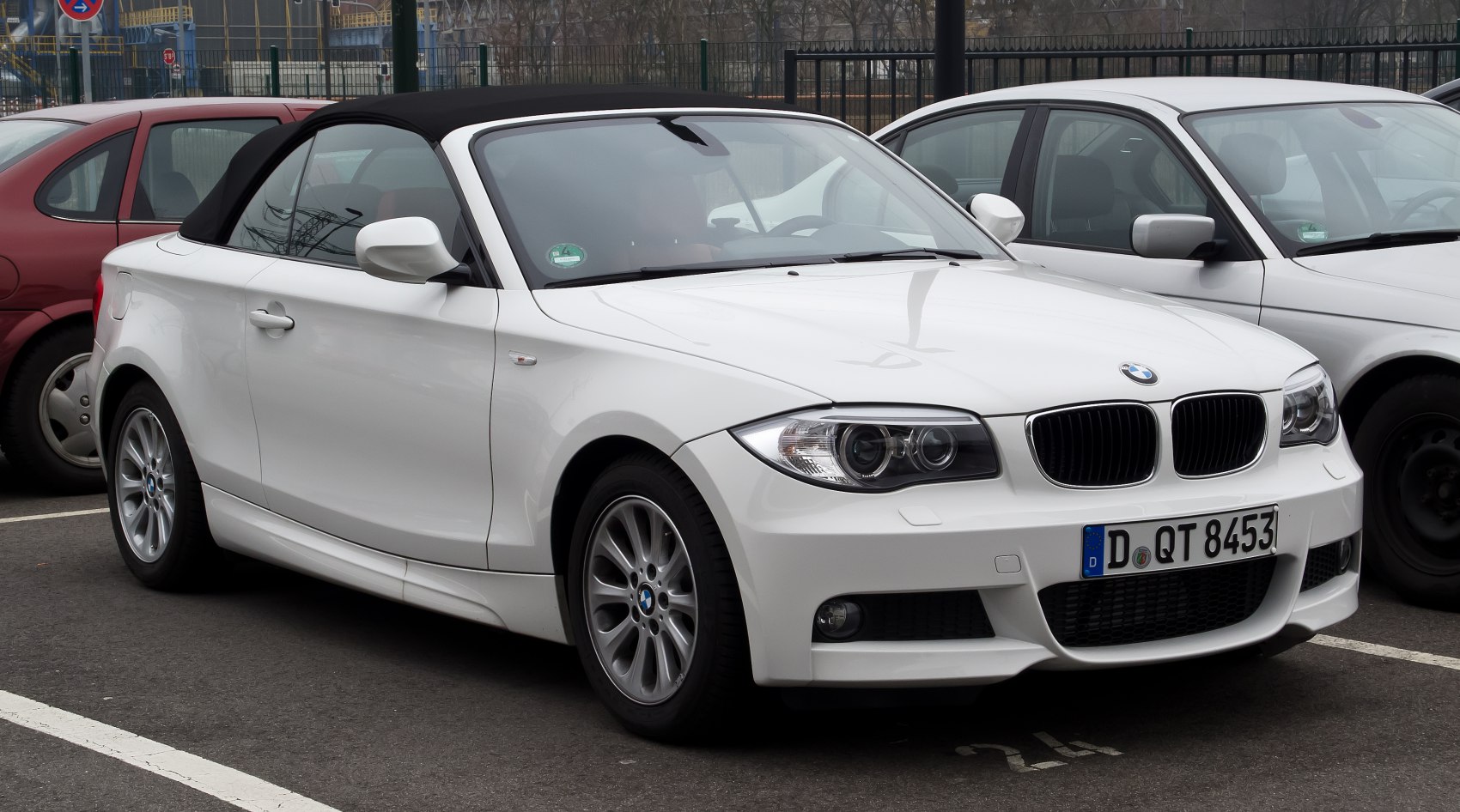 Front side view of convertible with soft top roof and alloy wheels