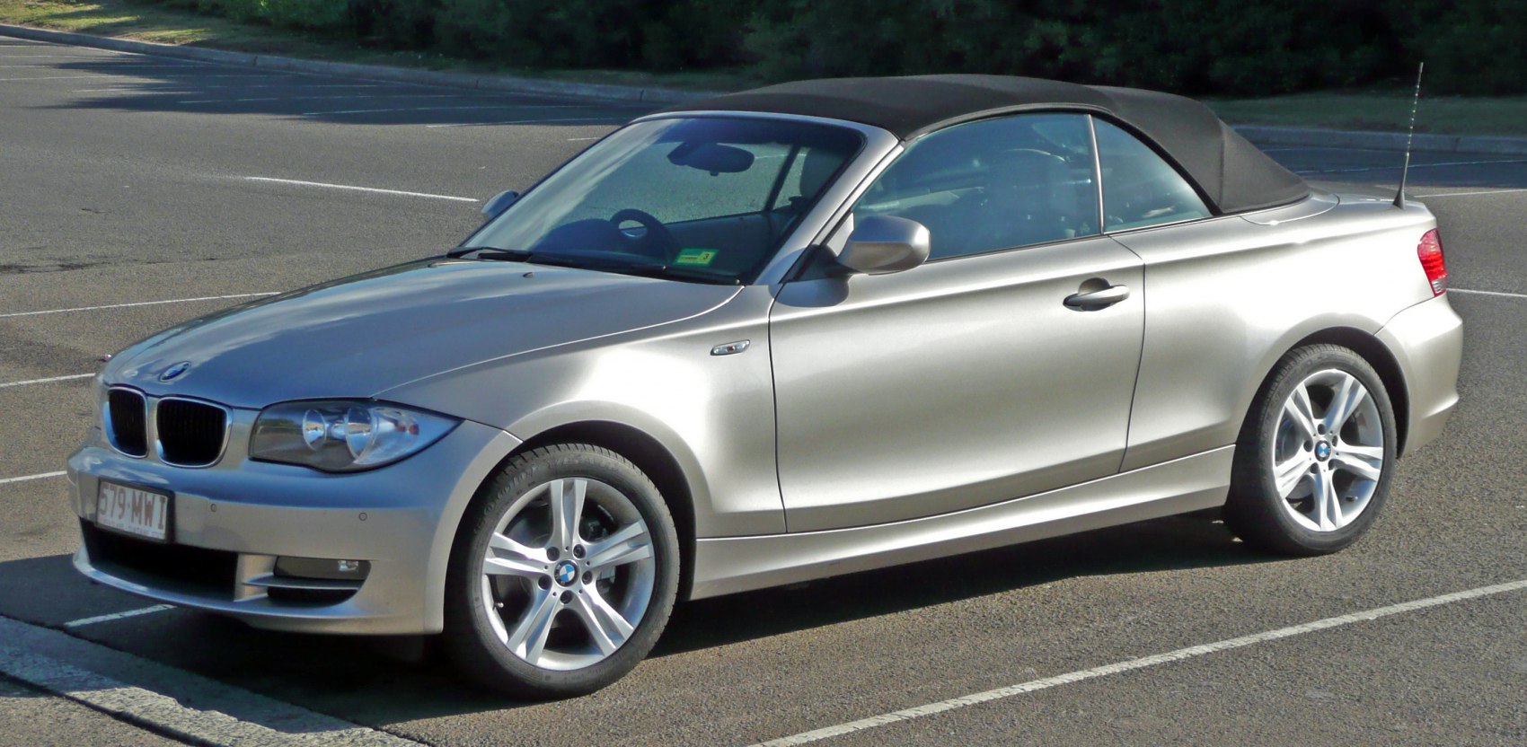 Silver convertible with closed soft top side view