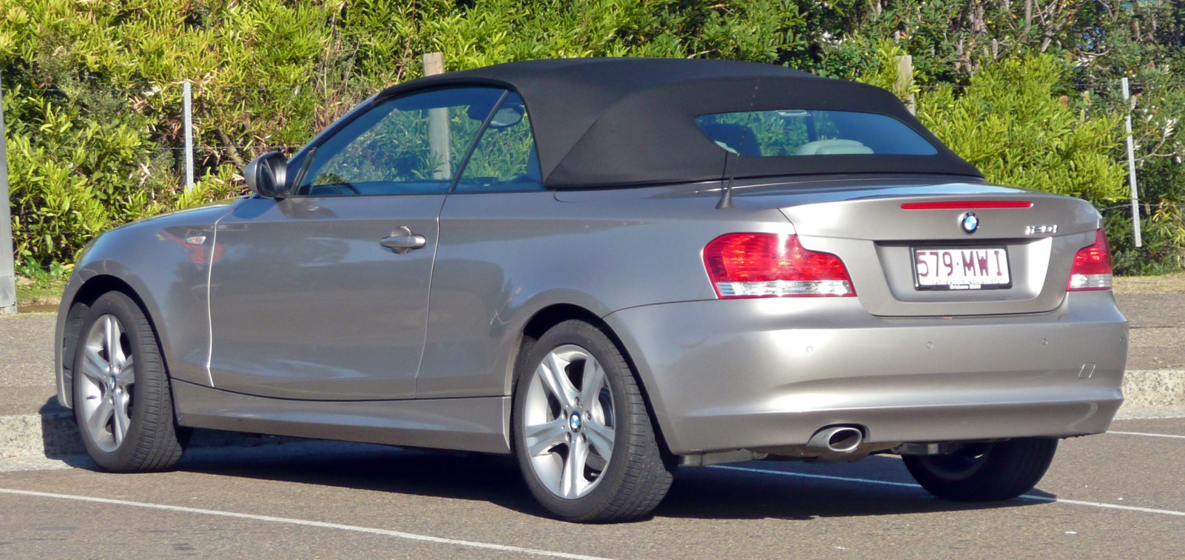 Rear side view of BMW convertible with soft top roof