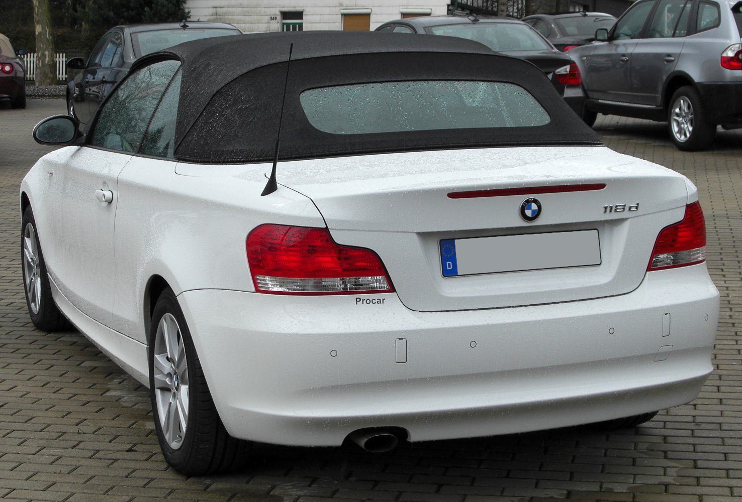 Convertible rear view with soft top and prominent taillights