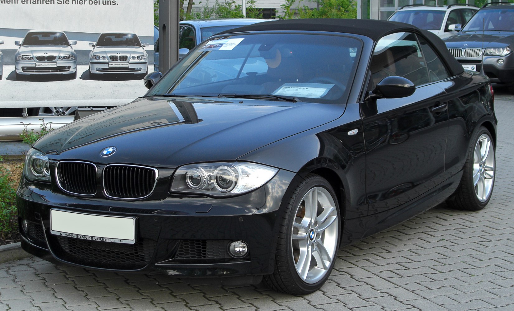 Front view with dual round headlights and alloy wheels