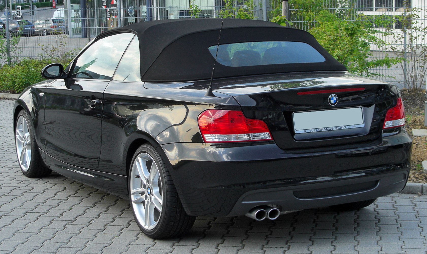 Rear view of convertible with soft top roof and dual exhaust