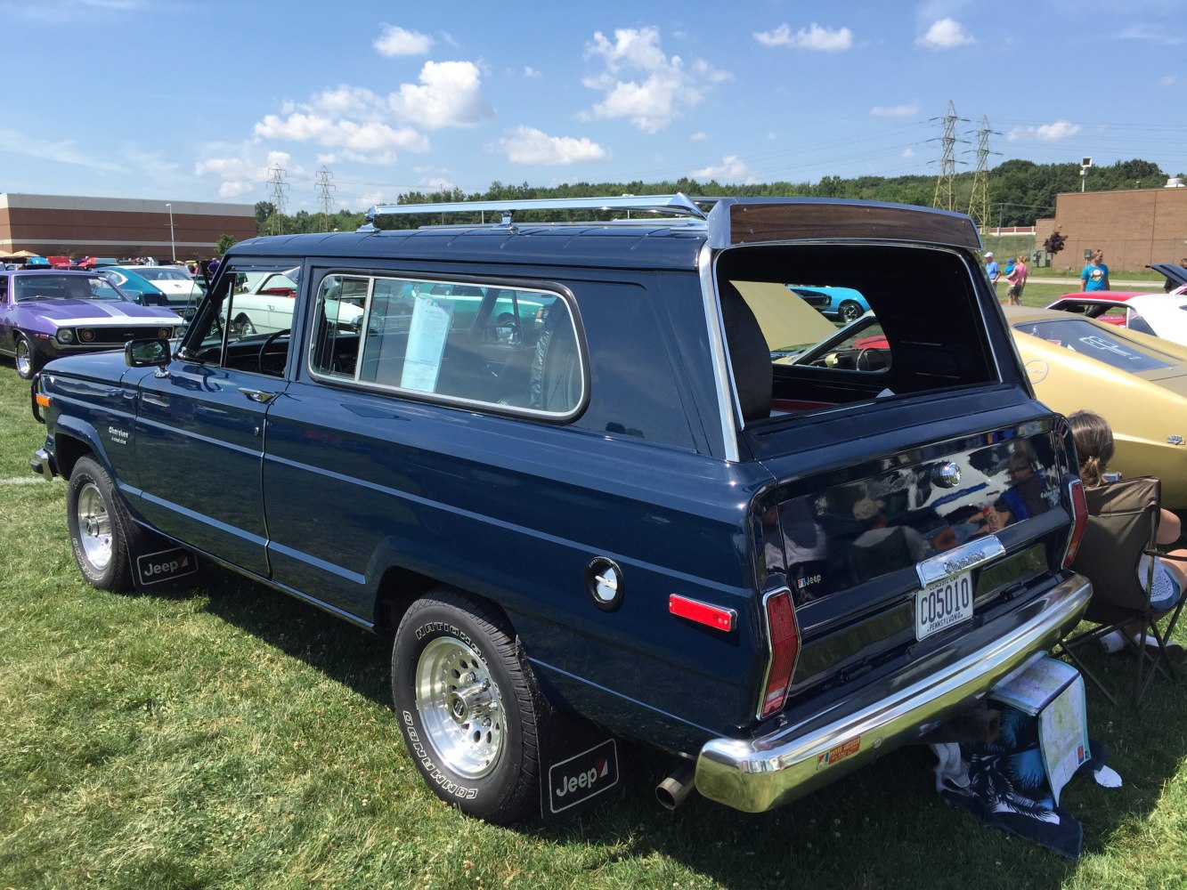Vintage SUV with raised rear tailgate and metal roof rack