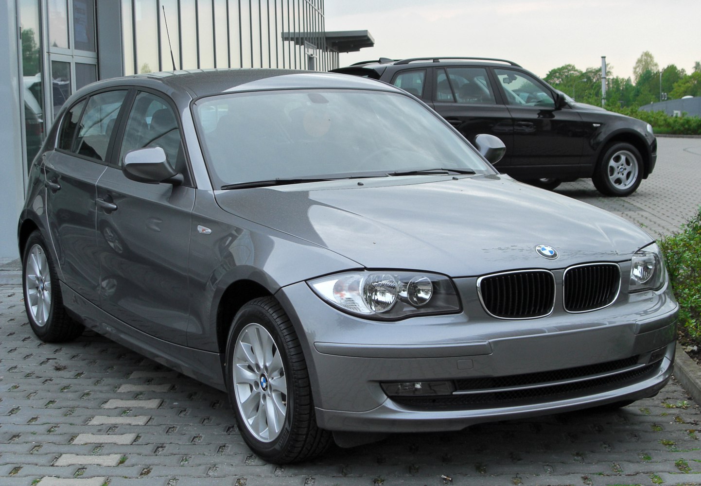 Grey 5-door hatchback with distinctive BMW front grille and headlights