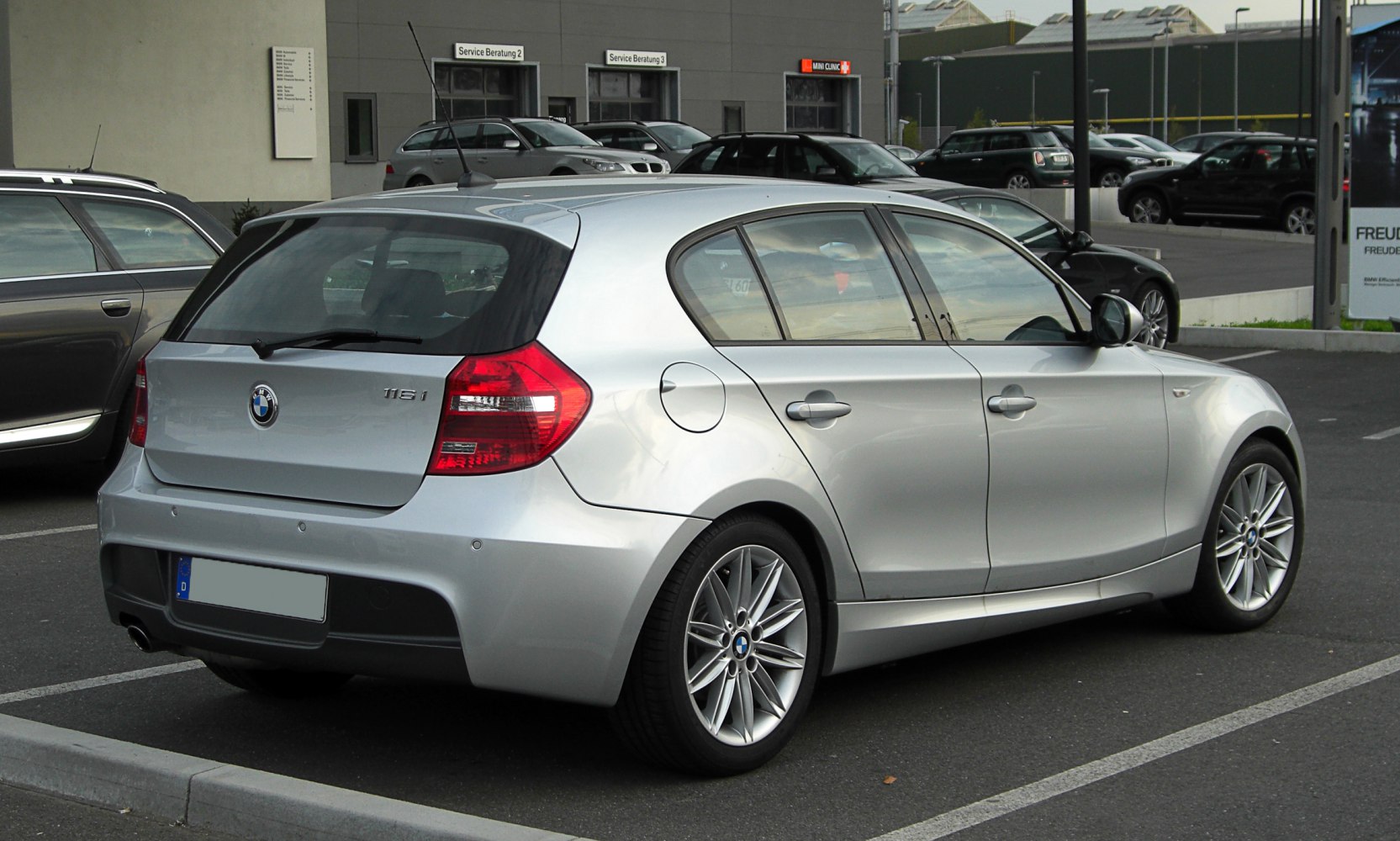 Silver 5-door hatchback rear side with alloy wheels and rear lights.