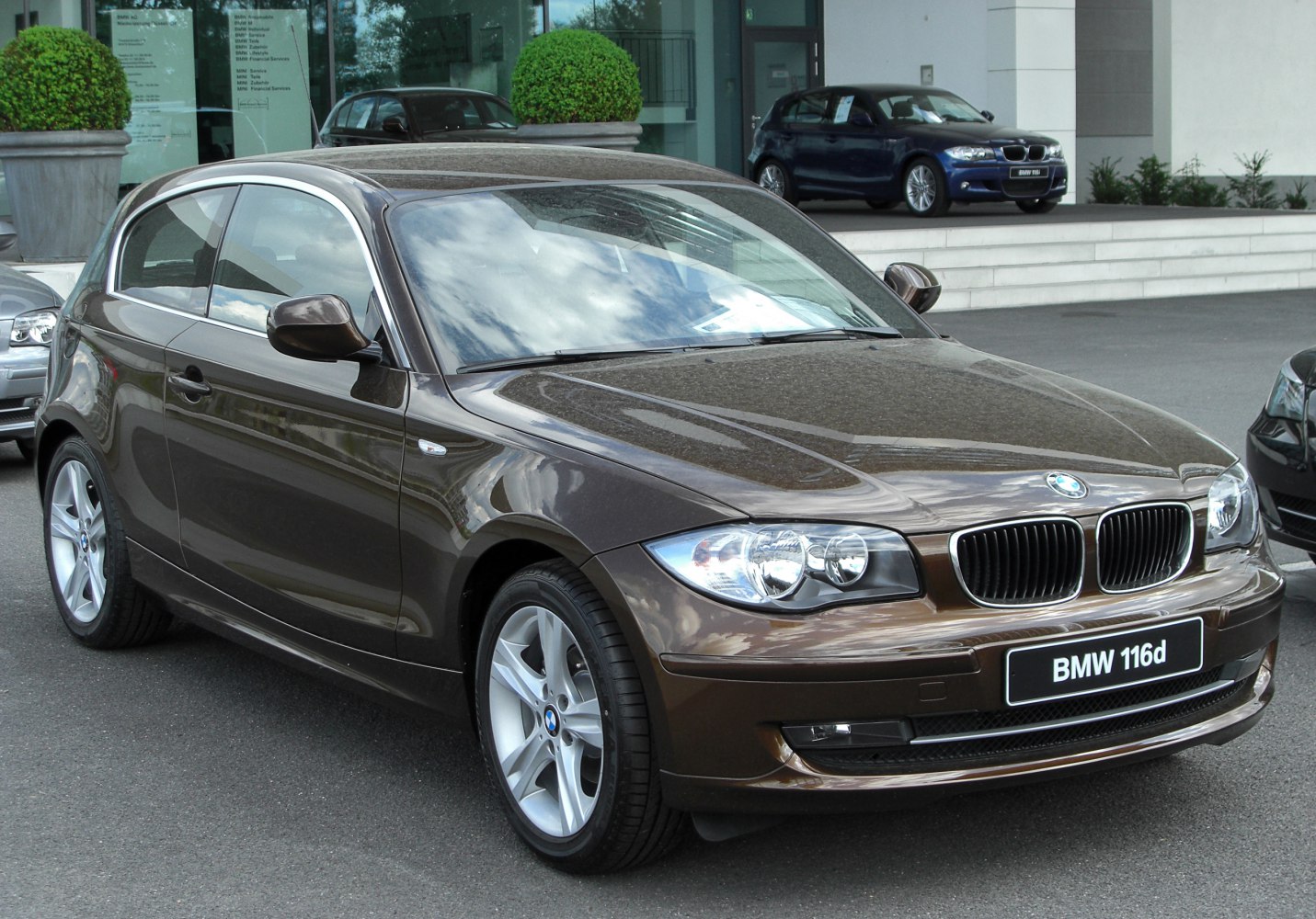 Front and side view of hatchback with alloy wheels and headlights