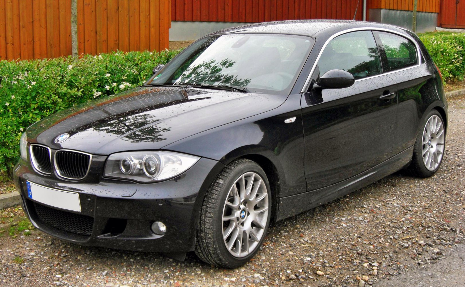 Front and side view of hatchback showing headlights and alloy wheels