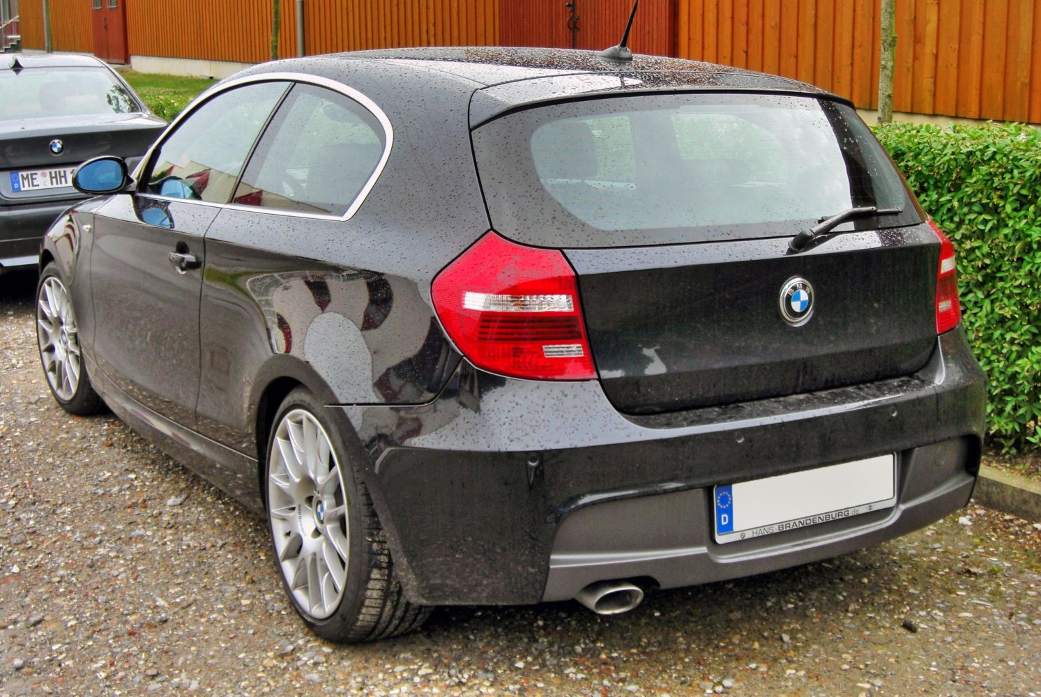 Rear 3-door hatchback with distinct tail lights and sporty alloy wheels.