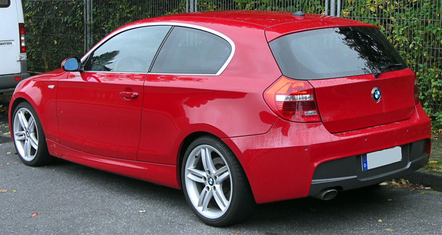 Red 3-door hatchback, rear side view with alloy wheels