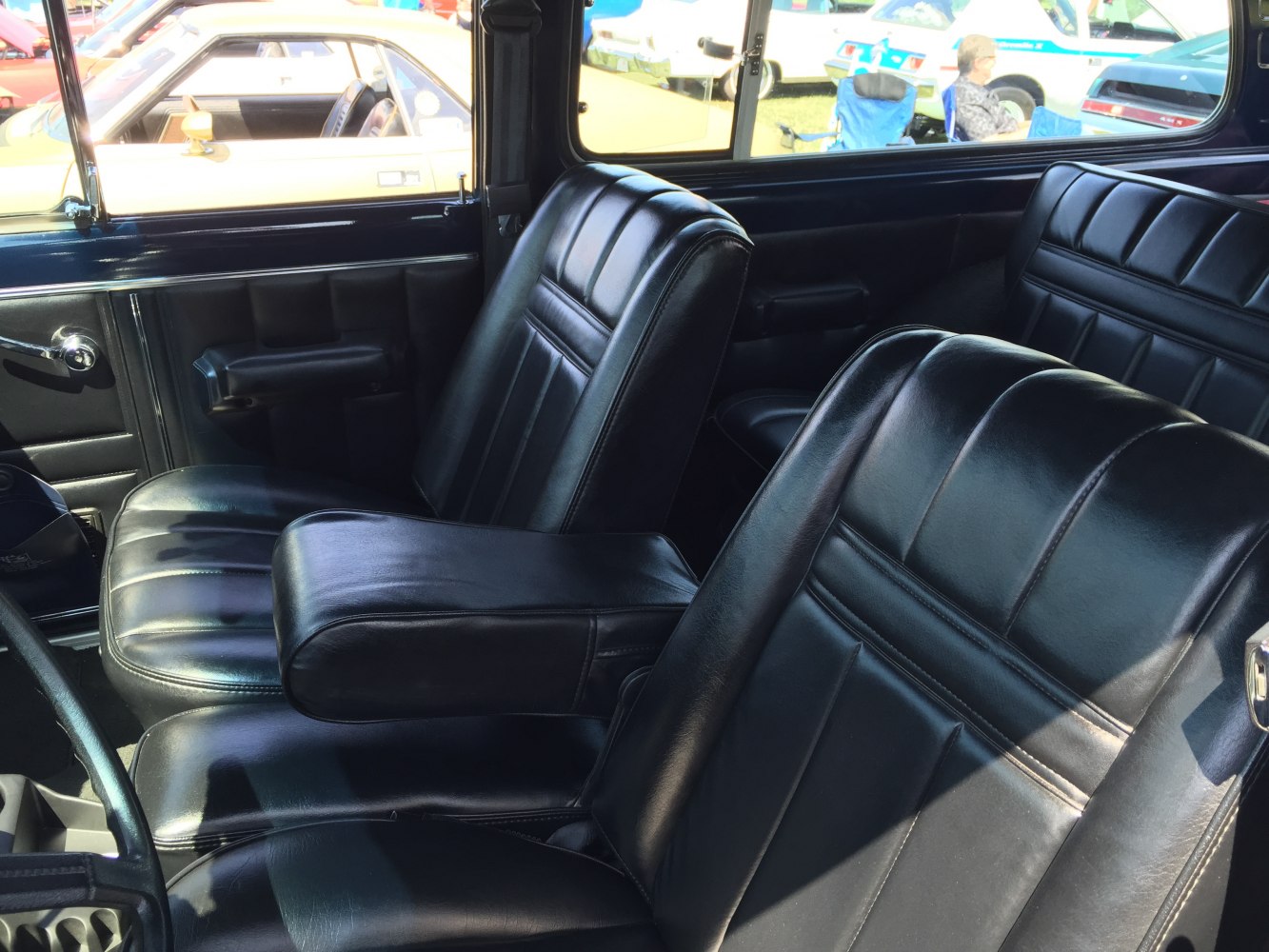 Black leather seats with armrest in a classic SUV interior