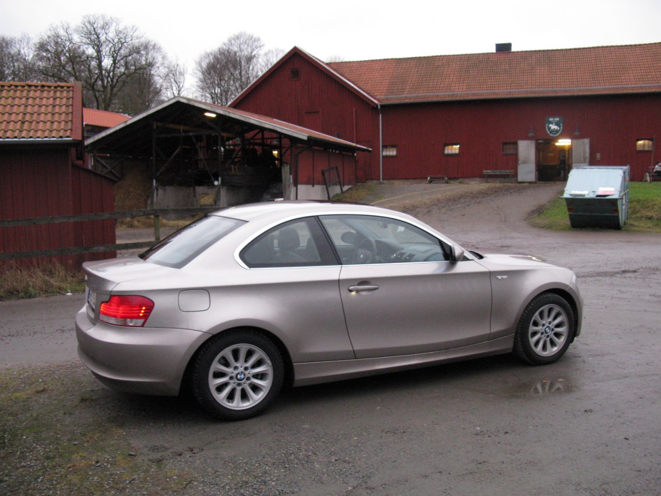 Silver two-door coupe with alloy wheels and rear side view
