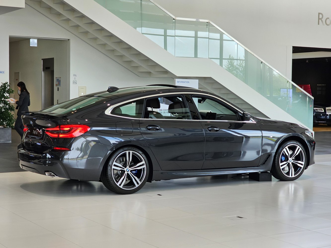 Rear side profile with sporty wheels and aerodynamic fastback roofline