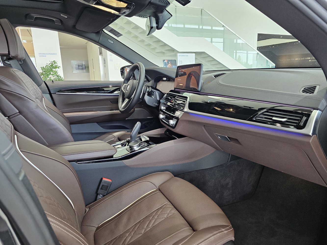 Brown leather seats with digital dashboard and ambient lighting