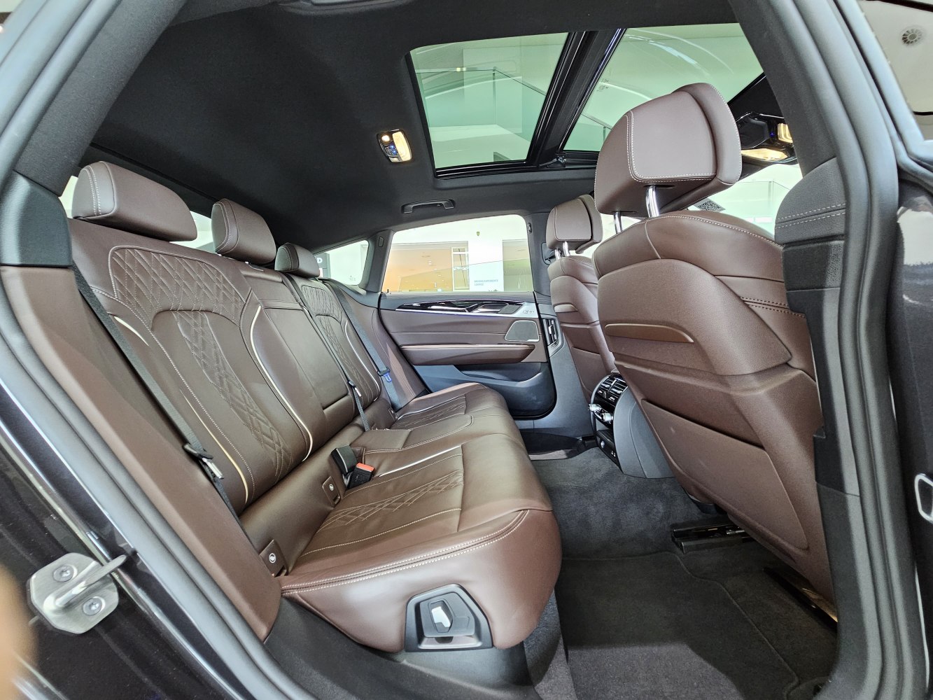 Luxury brown leather rear seats with panoramic sunroof
