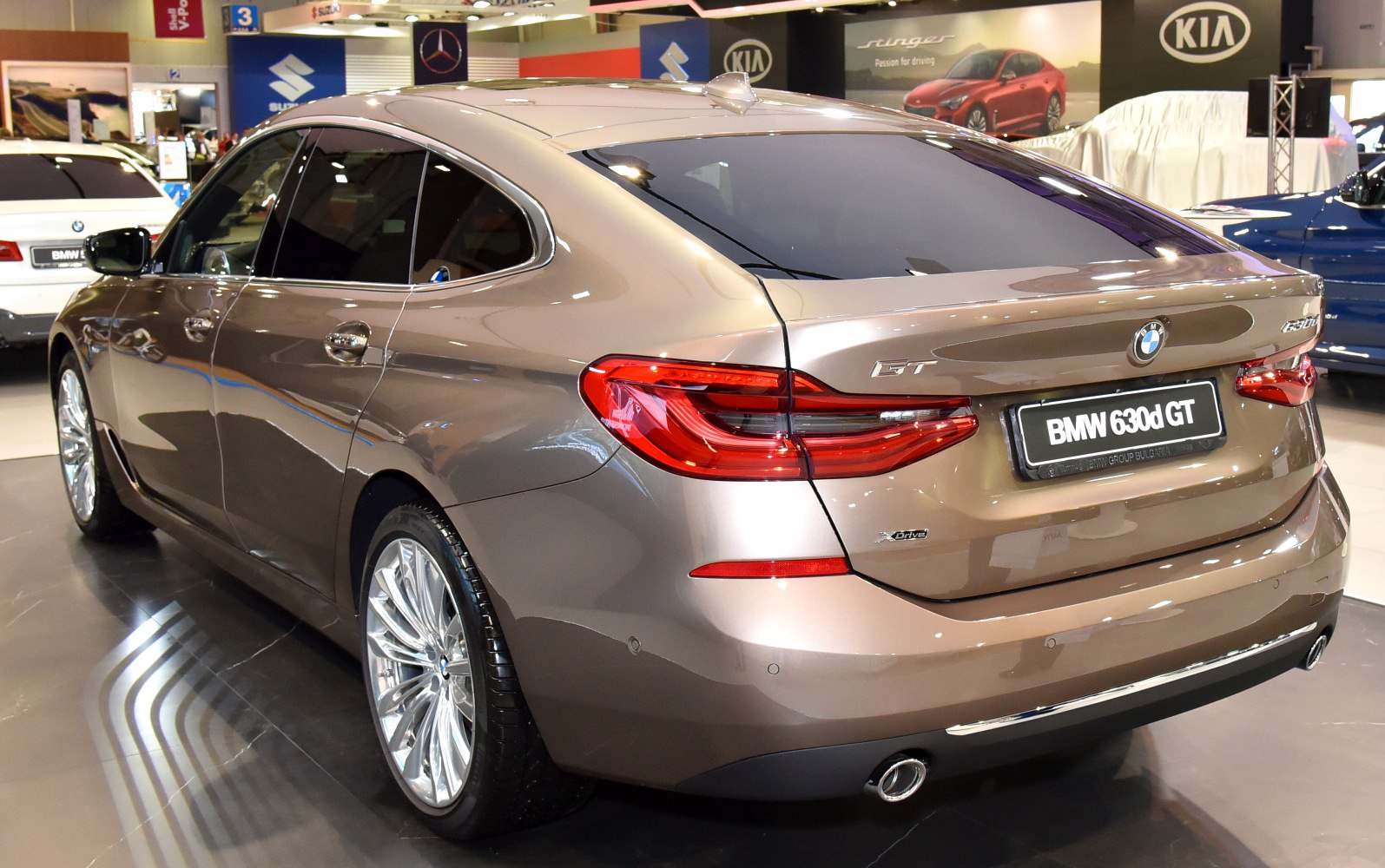 Sleek rear three-quarter view with distinct taillights and smooth roofline