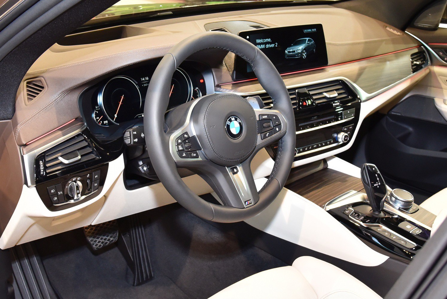 Luxury interior with steering wheel, digital dashboard, and center console.