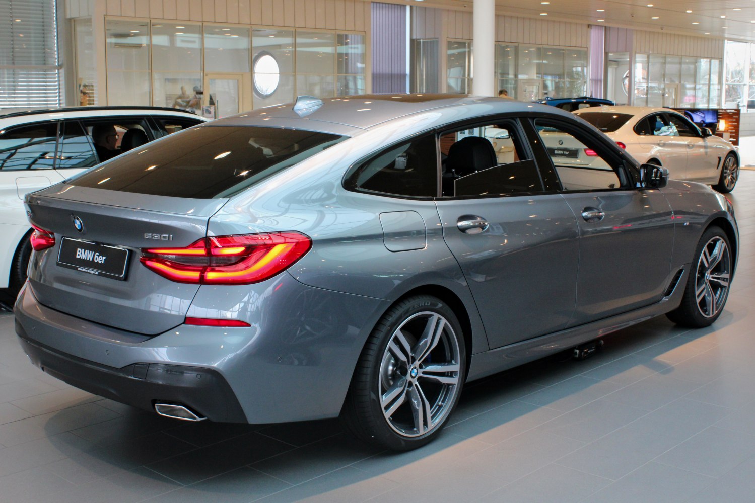 Rear side view with distinctive LED tail lamps and smooth hatchback design