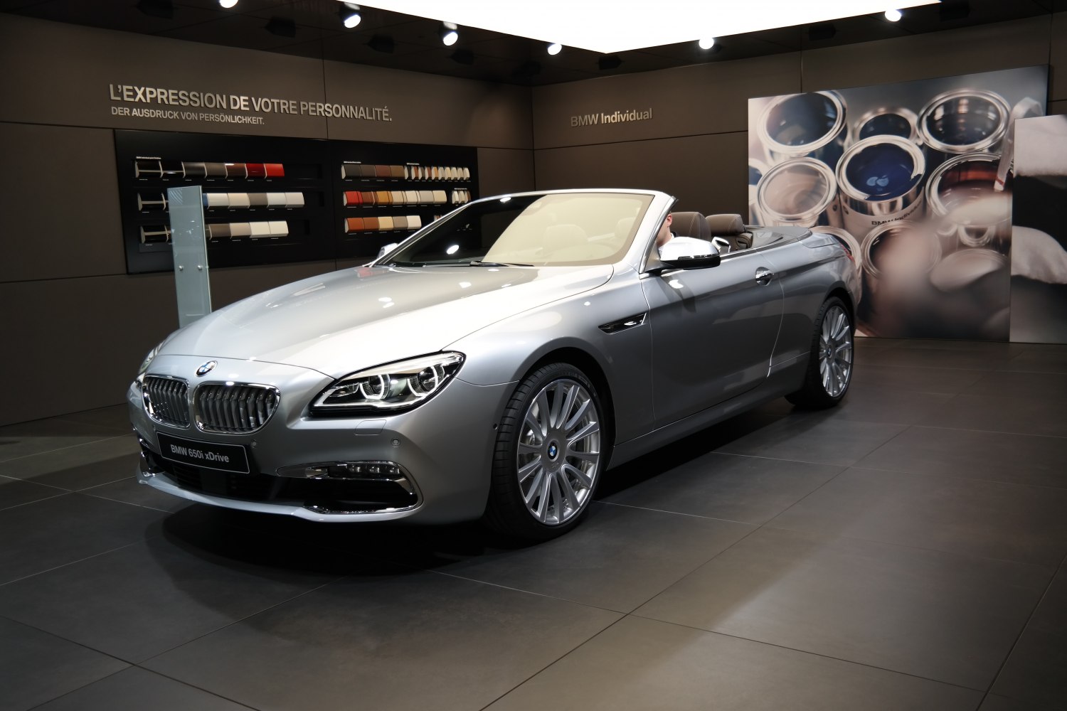 Front and side view of a silver convertible with detailed headlights and alloy wheels