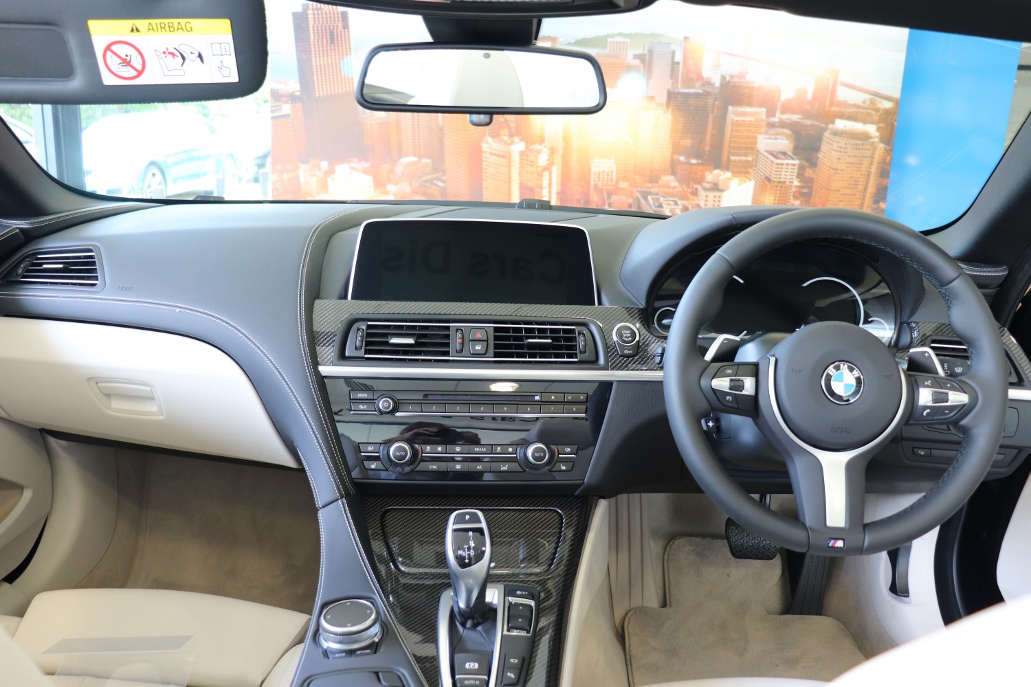 Dashboard, center console, steering wheel with controls, carbon fiber trim interior