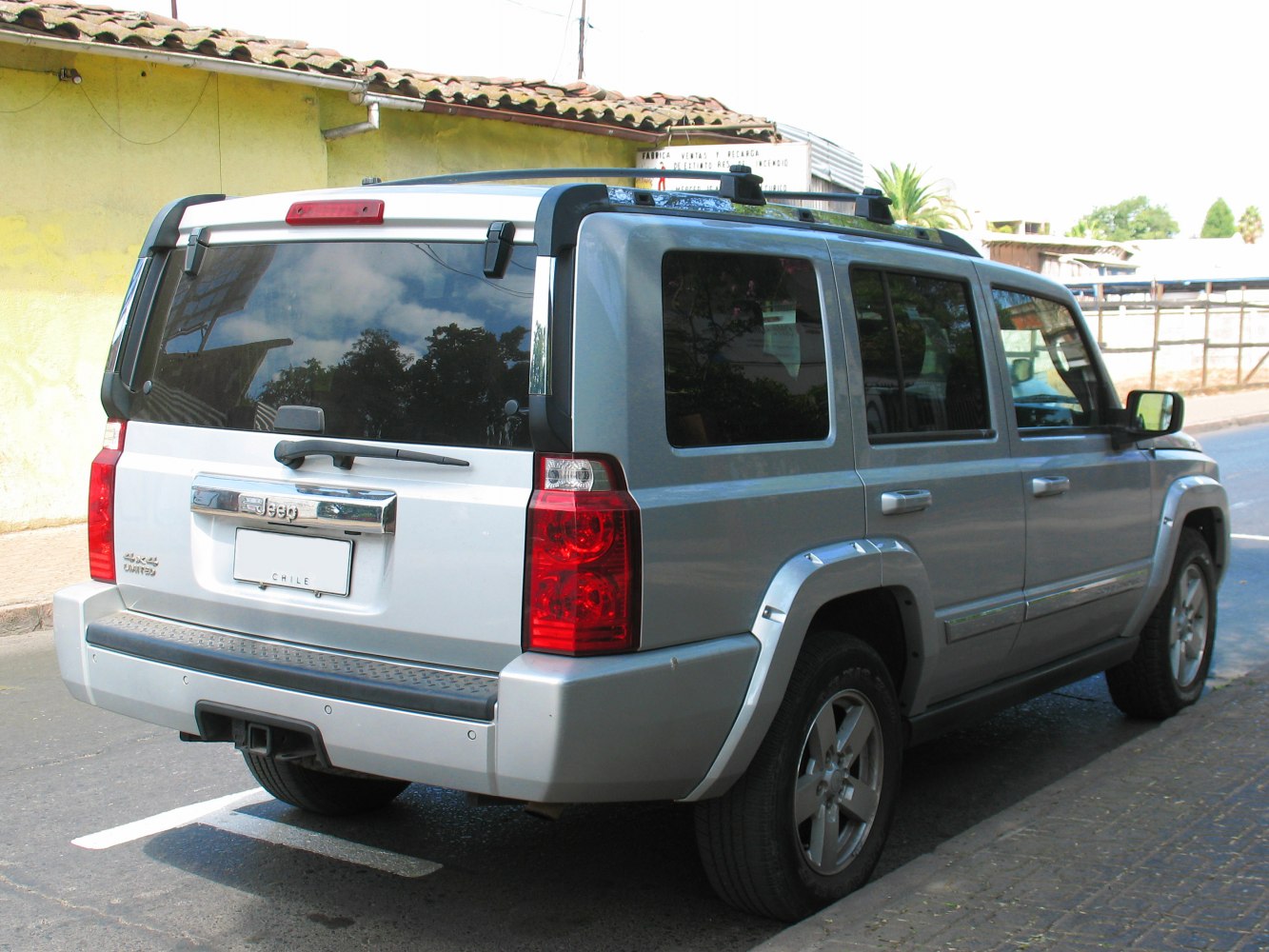Rear view of boxy SUV with tinted windows and roof rails
