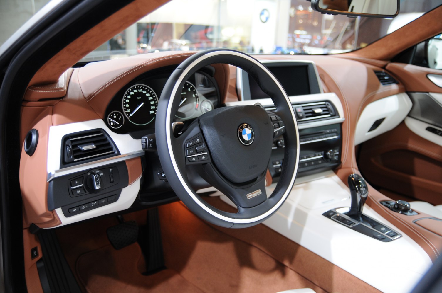 Luxury car interior with steering wheel and advanced dashboard controls