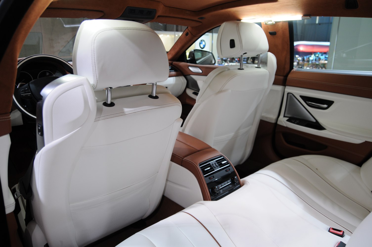 White leather interior with brown accents and rear air vents