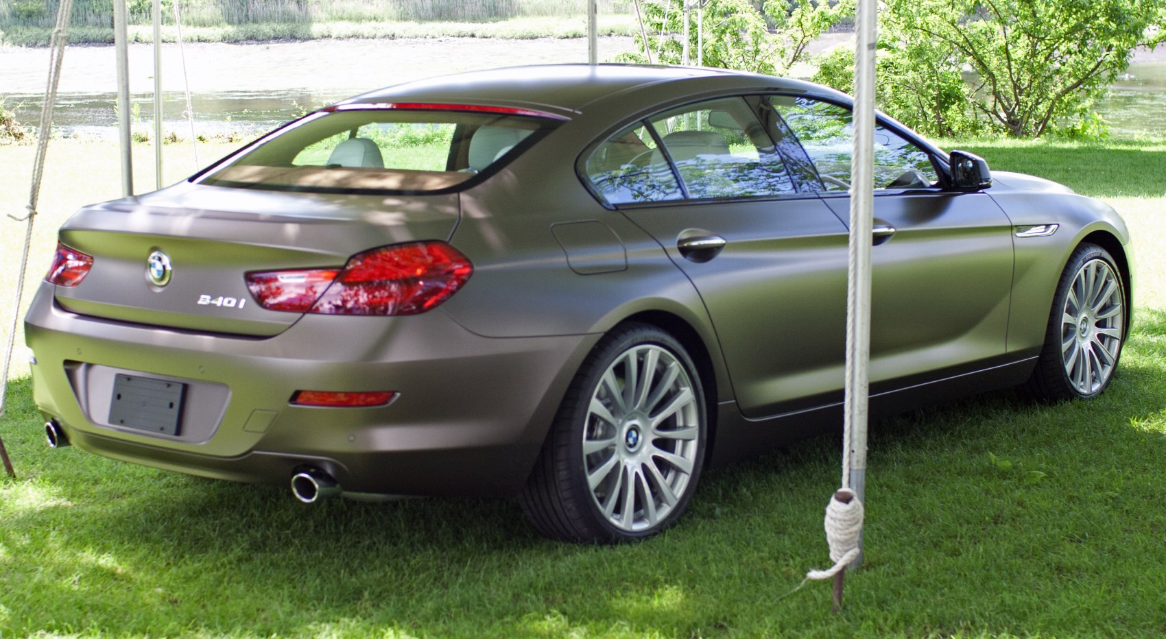 Rear side view of luxury coupe with twin exhausts and multi-spoke wheels