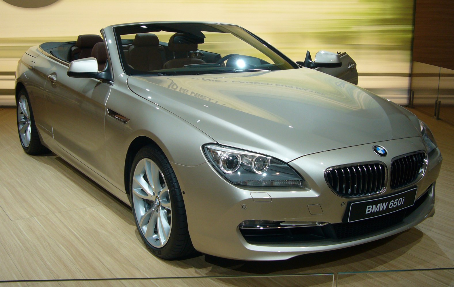 Front and side view of convertible luxury car with open roof and alloy wheels