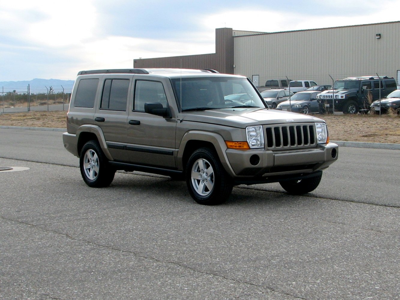 Front and side view of mid-2000s SUV with rugged design and five-door layout