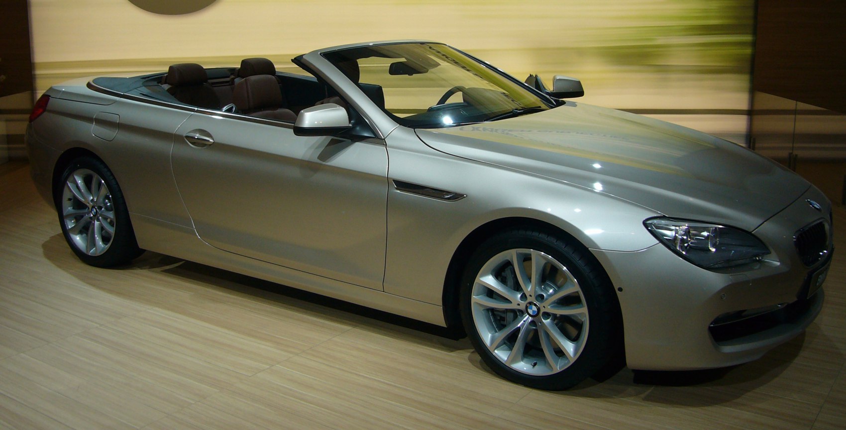 Silver luxury convertible with alloy wheels and open top